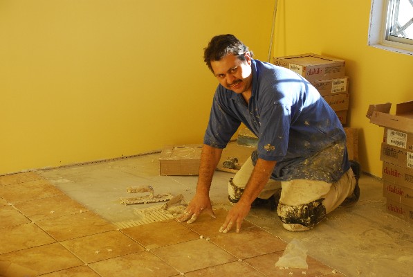 Luis Carlos laying tile!